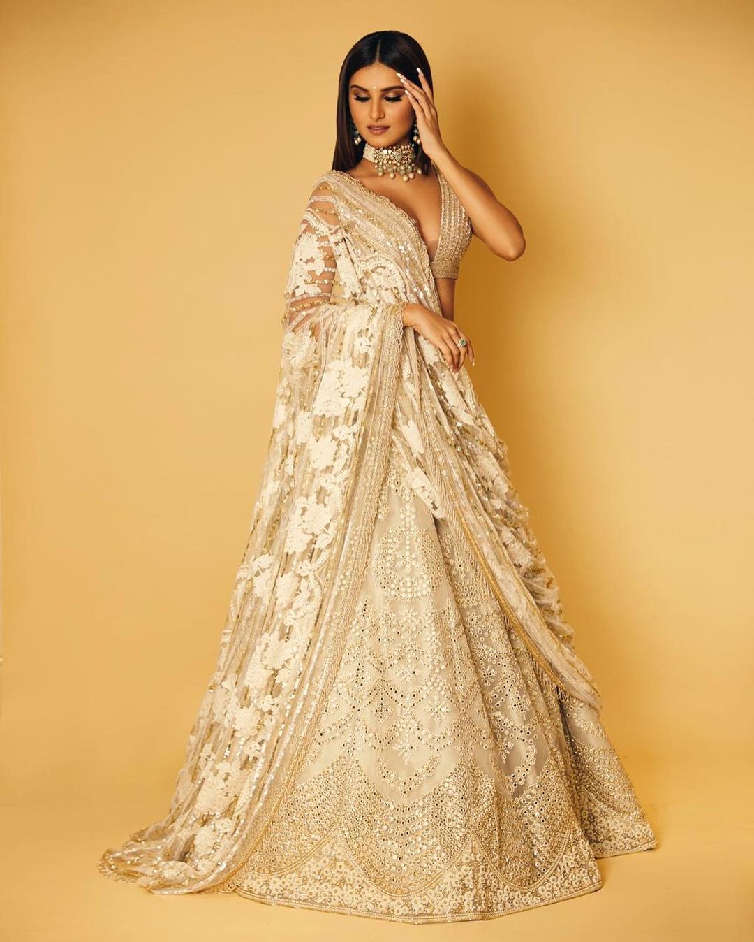 Tara Sutaria looks elegant in the white and golden lehenga.