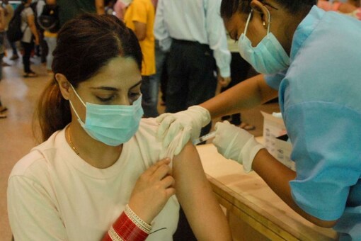 A medic administers a dose of Covid-19 vaccine to a beneficiary at a District Hospital in Noida. (PTI)