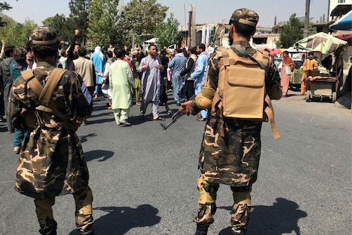 Taliban soldiers stand by as Afghans shout slogans during an anti-Pakistan demonstration, near the Pakistan embassy in Kabul, Afghanistan, Tuesday, Sept. 7, 2021. (AP Photo/Wali Sabawoon)
