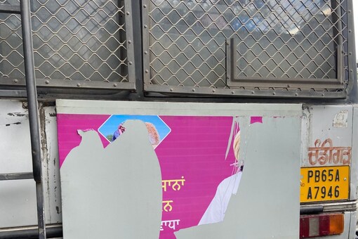 A partially torn poster that featured former CM Amarinder Singh’s photo on the back of a Punjab state bus. (News18)