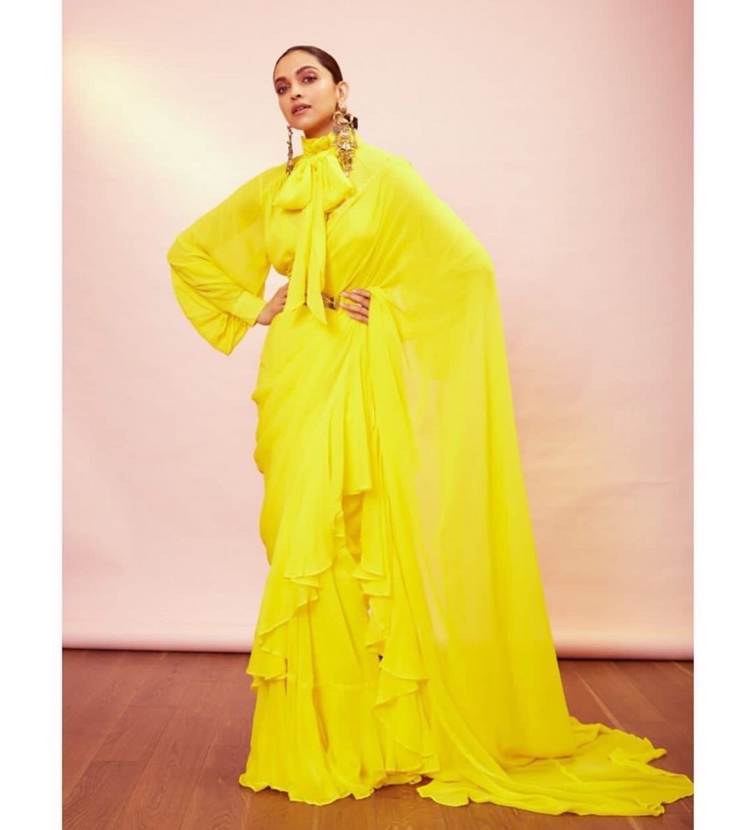 Deepika Padukone goes vibrant in the frilly yellow saree. 