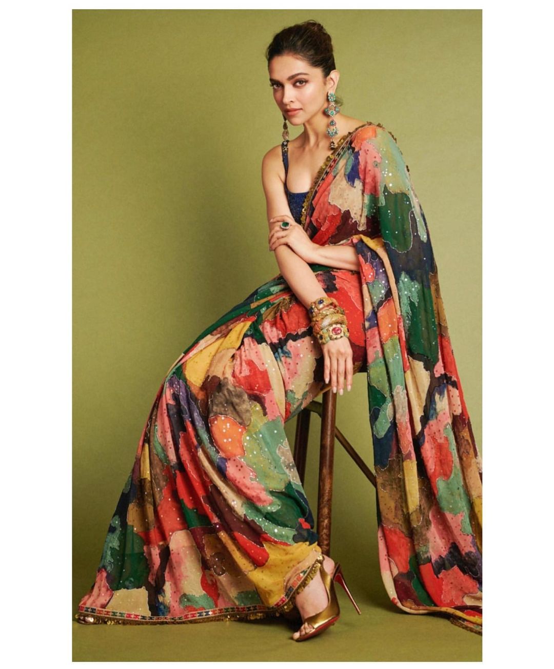 Deepika Padukone cuts a statusque figure in the multicoloured saree. 