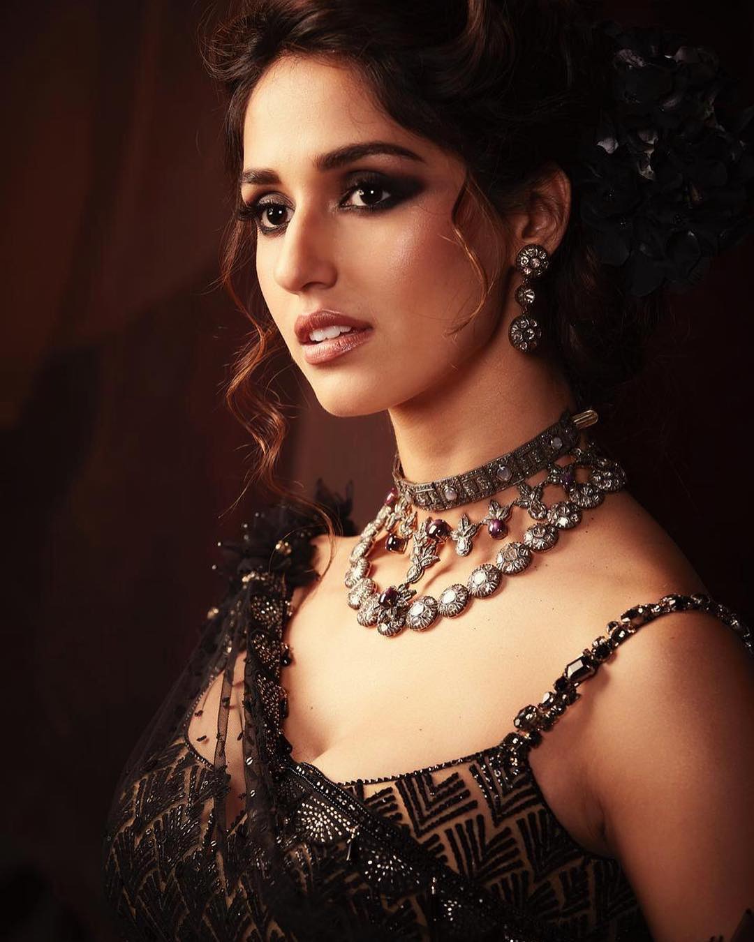 Disha Patani oozes elegance in the black sheer saree. 