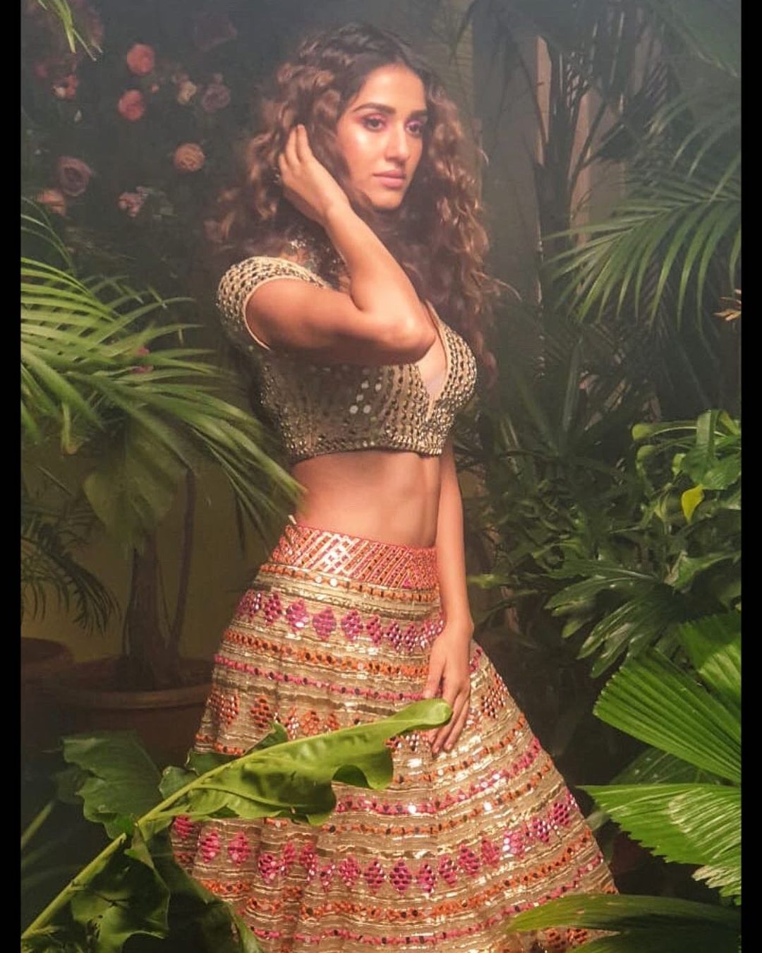 Disha Patani flaunts toned body in the mirrorwork lehenga. 