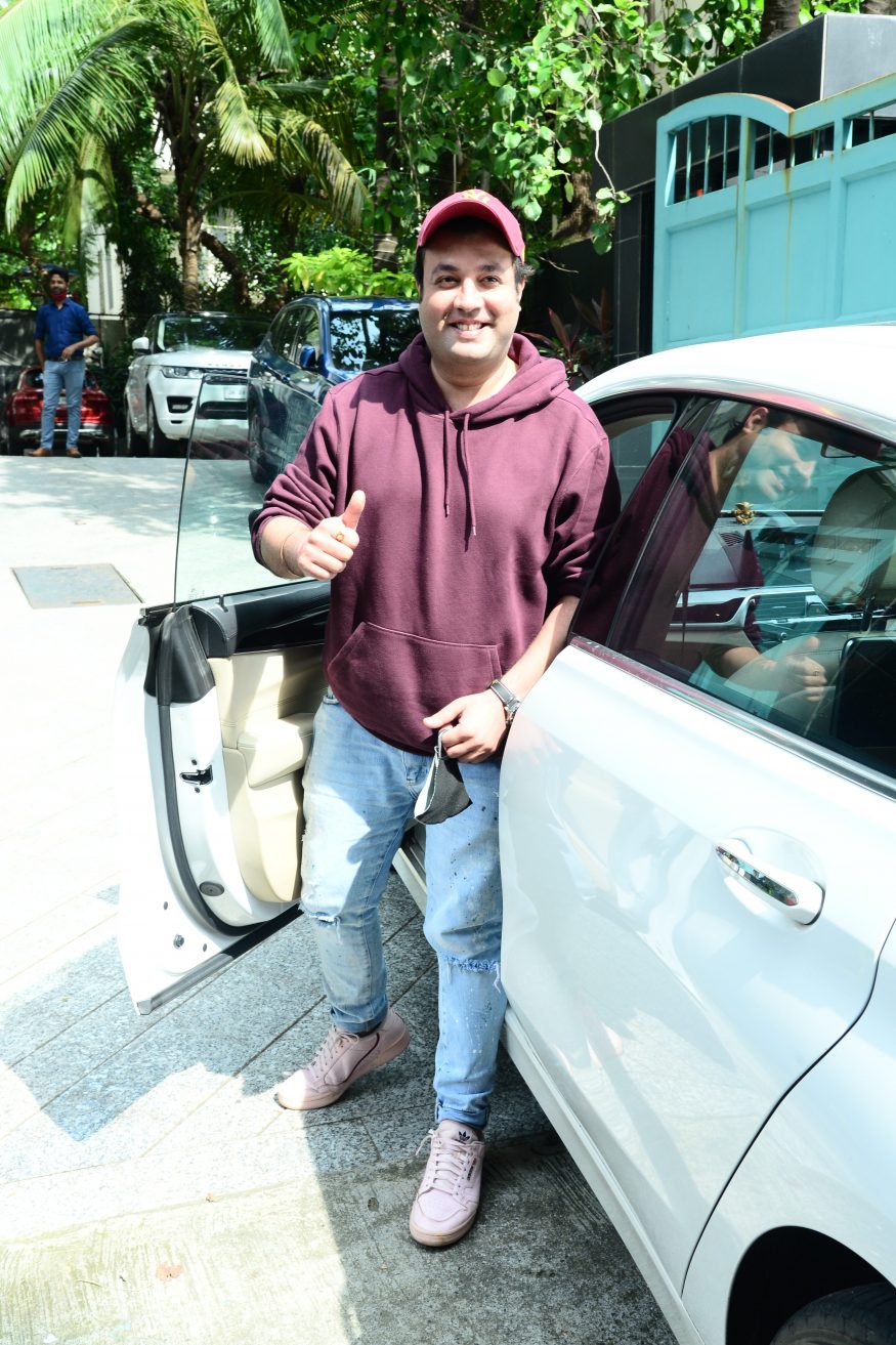 Varun Sharma gestures to the media.