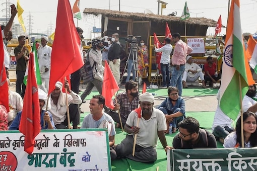 Farmers block a road during 'Bharat Bandh' against the Centre's three new farm laws, at Ghazipur border in New Delhi on Monday. (Image: PTI Photo/Atul Yadav)