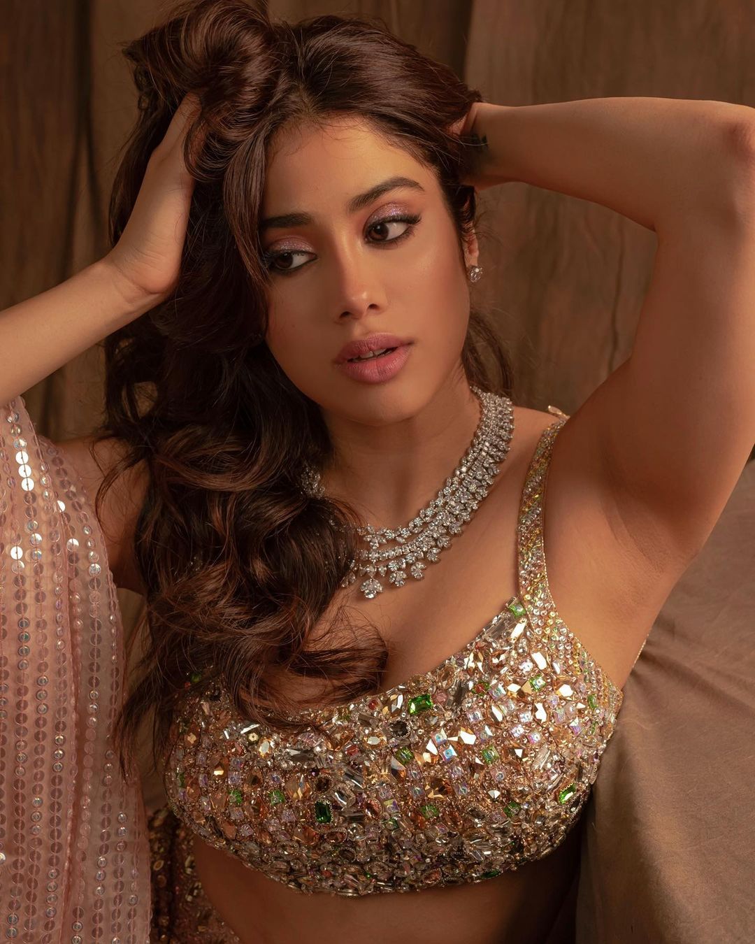 Janhvi Kapoor looks sexy in the embellished blouse.