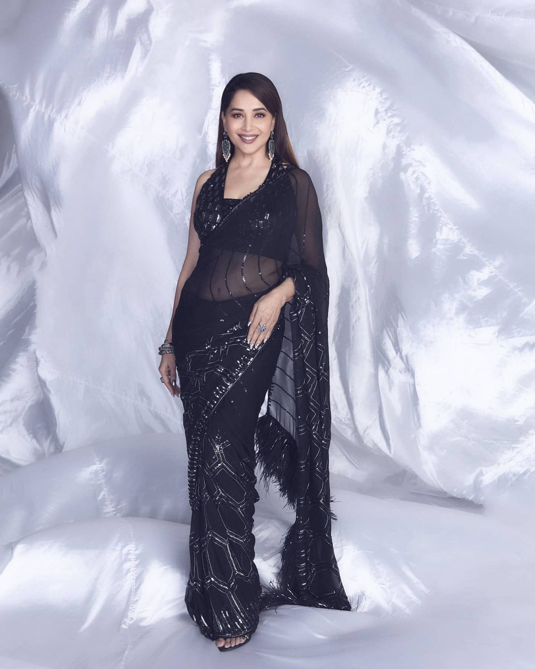 Madhuri Dixit Nene in a sheer balck saree is 'too glam to give a damn.' 