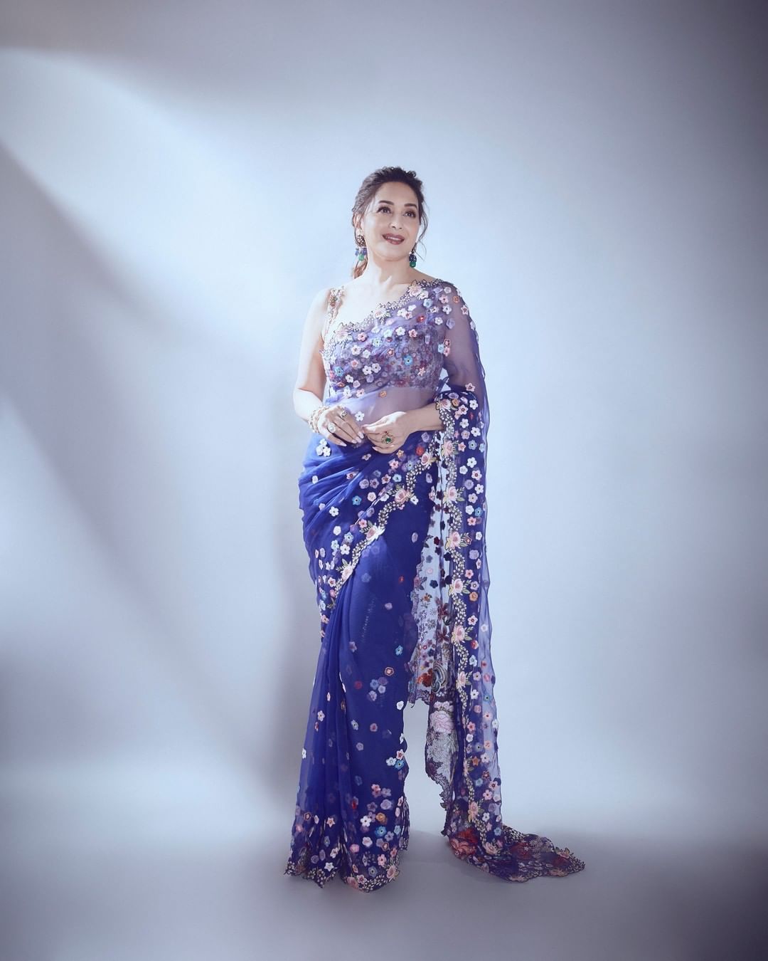 Madhuri Dixit looks ethereal in a blue floral saree.