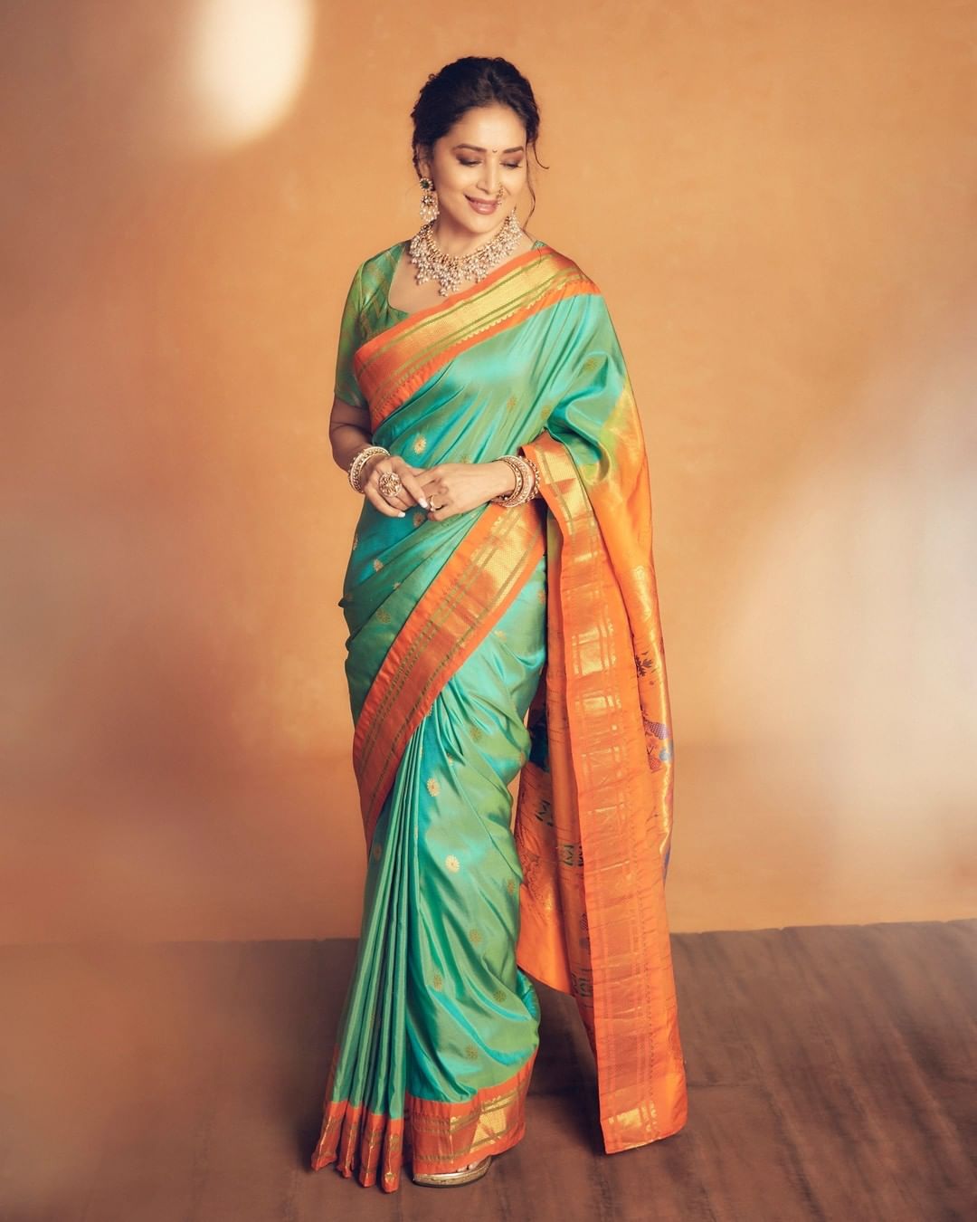 Madhuri Dixit looks gorgeous in the traditional silk saree. 