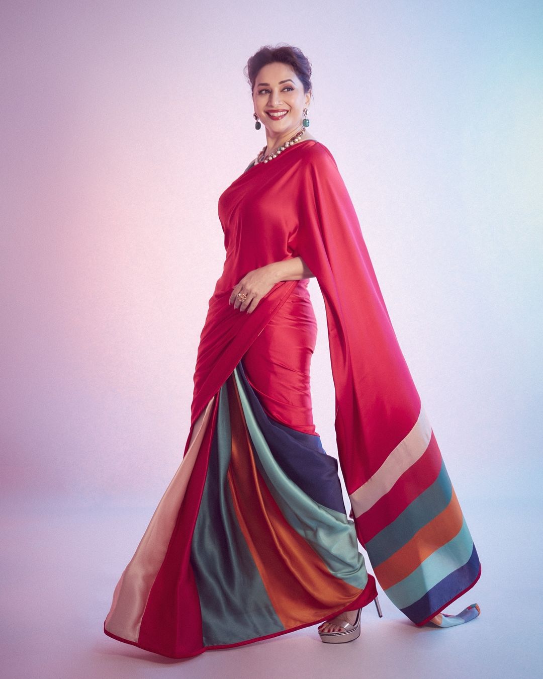 Madhuri Dixit looks astounding in the red silk saree.