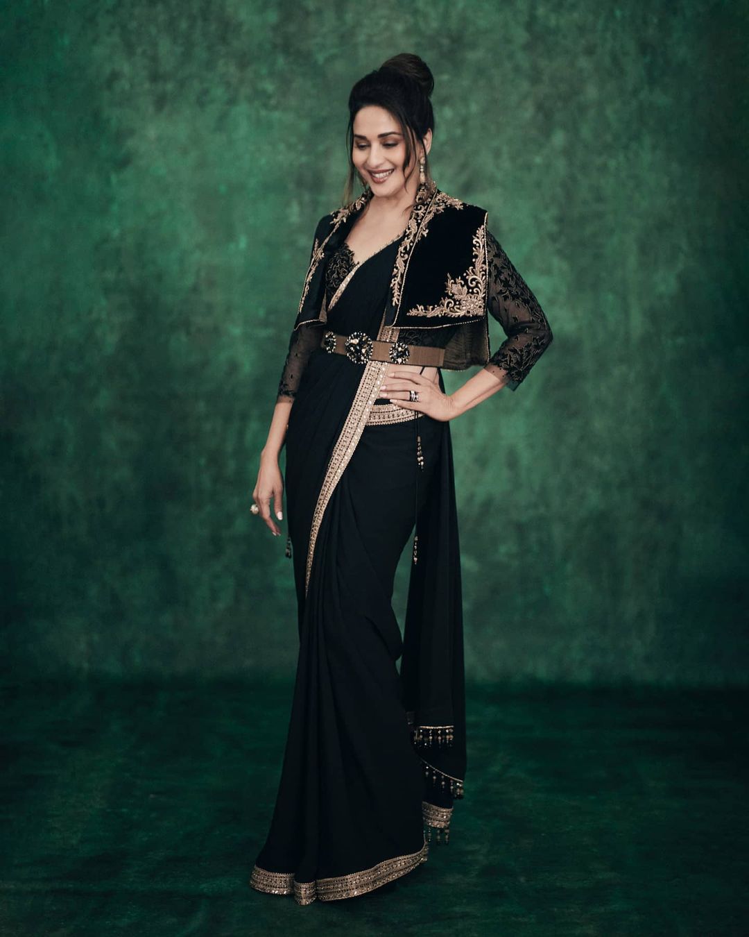 Madhuri Dixit Nene works her charm in the belted saree with a short jacket.