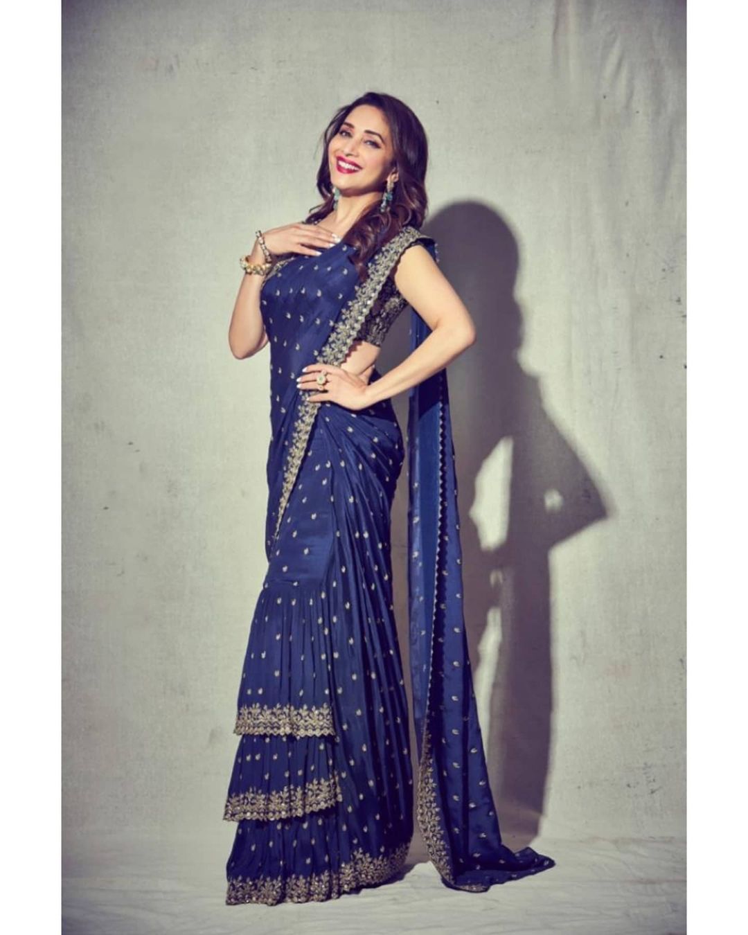Madhuri Dixit keeps it playful in the stitched tiered saree. 