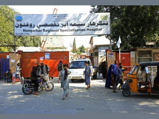 Afghan people are pictured outside the Nangarhar Regional Specialization Hospital after explosions in Jalalabad on September 18, 2021. (AFP)