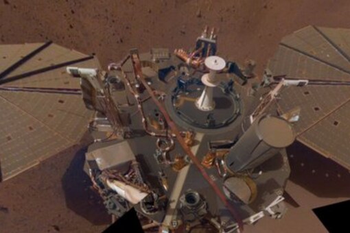 The official Twitter handle of the InSight mission tweeted a picture of the lander partially covered in dust.. (Image Credits: Twitter/@NASAInSight)
