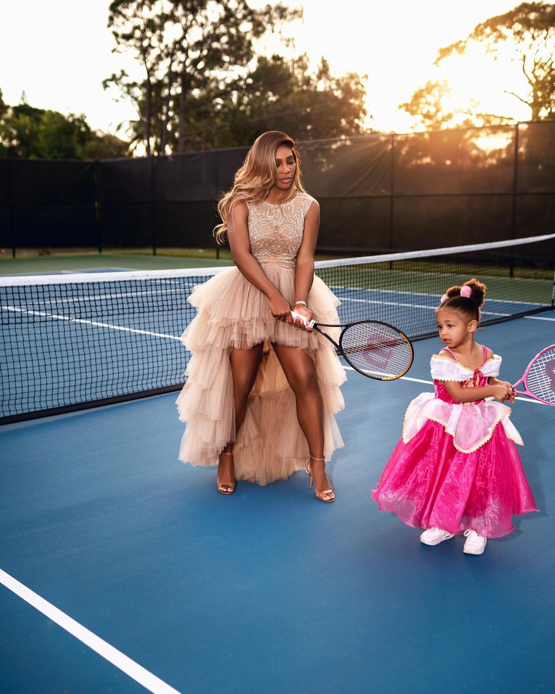 Wearing a beige gown by Johana Hernandez’s Glaudi label, Serena poses with her daughter Olympia in a tennis court. (Image: Instagram) Wearing a beige gown by Johana Hernandez’s Glaudi label, Serena poses with her daughter Olympia in a tennis court. (Image: Instagram)