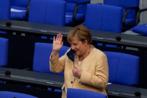German Chancellor Angela Merkel waves to an acquaintance as she arrives in the plenary hall for a session at the Bundestag, the German lower house of parliament, in Berlin on September 7, 2021, the last one before general elections on September 26, 2021.
John MACDOUGALL / AFP