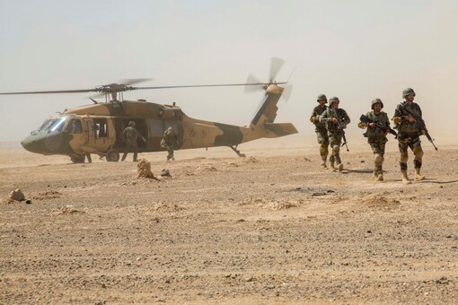 Afghan National Army 215th Corps troops disembark an Afghan Air Force (AAF) Black Hawk helicopter during a troop re-supply at Camp Shorabak in Helmand Province July 28, 2018. Picture taken July 28, 2018. To match Special Report USA-AFGHANISTAN/PILOTS. U.S. Marine Corps/1st Lt. Kathleen Kochert/Handout via REUTERS THIS IMAGE HAS BEEN SUPPLIED BY A THIRD PARTY. 