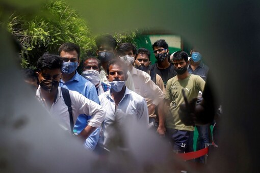 People wait to receive a dose of COVISHIELD at a hospital. (Image: Reuters)