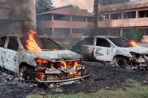 Cars set alight by a mob during a protest over footage of a Koran being placed on the knee of a Hindu god during celebrations of Durga Puja, in Bangladesh's Noakhali. (Image: AFP)