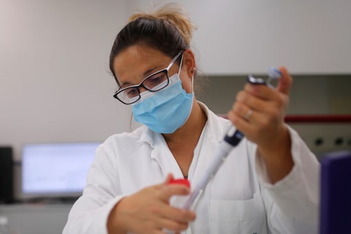 A researcher works on cell culture in a laboratory as part of a project to develop a Covid nasal spray that could protect against Covid-19, at the University of Tours, France, on September 15, 2021. (REUTERS/Stephane Mahe)