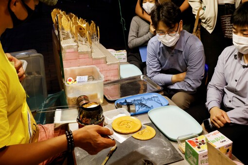 A street vendor sells Dalgona candy from the Korean Netflix series 