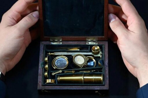 James Hyslop, Head of Scientific Instruments, Globes and Natural History at Christie's, demonstrates the Darwin Family Microscope, owned and used by the English naturalist and founder of the concept of evolution, Charles Darwin, which will be offered at auction as part of Christie's Classic Week, London, Britain, October 14, 2021. Credits: Reuters.