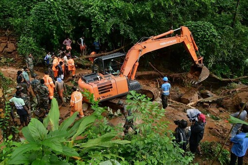 Rapid Action Force (RAF) and Kerala Fire and Rescue personnel during rescue operations at the site of landslide at Kavali in Kottayam district on Oct 17. (PTI Photo)