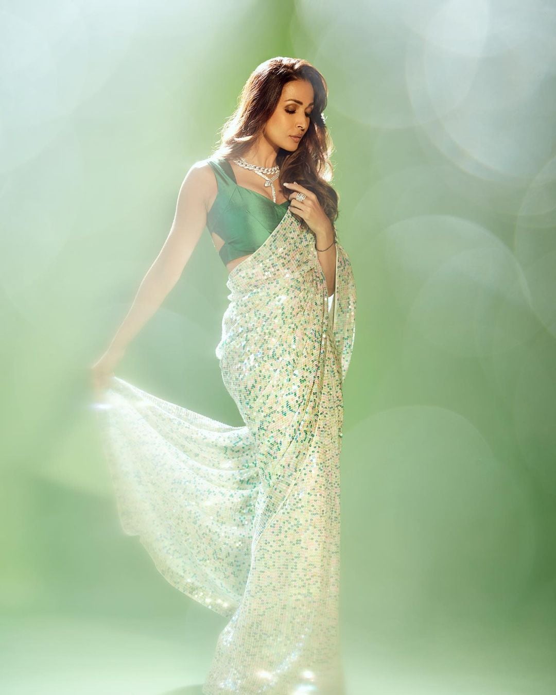 A sequenced satin saree, just like Malaika Arora, would make heads turn at family gatherings. (Image: Instagram)