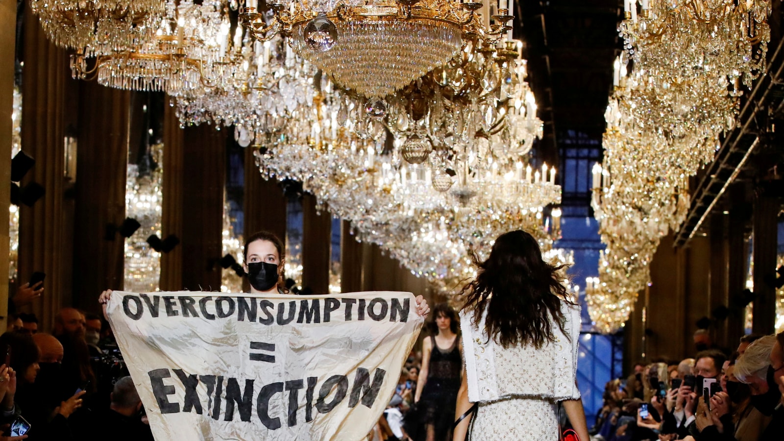 Climate change protester crashes Louis Vuitton catwalk show in Paris