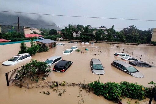 Submerged cars are seen at a flooded hotel resort as extreme rainfall caused the Kosi River overflow at the Jim Corbett National Park in Uttarakhand. (AP Photo/ Mustafa Quraishi) 