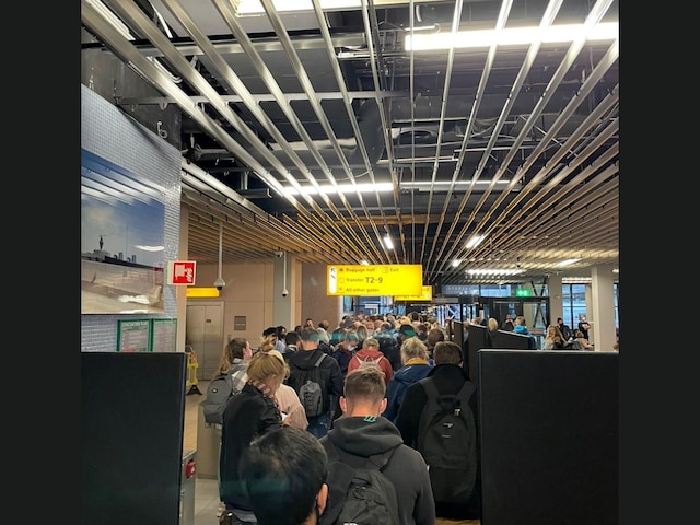 Passengers travelling from South Africa queue to be coronavirus disease tested after being held on the tarmac at Schiphol Airport, Netherlands. (Image: Reuters)