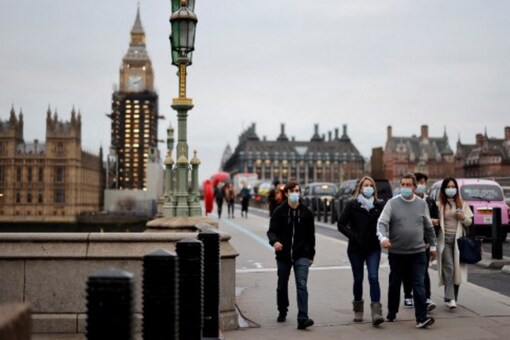 People walk past the Big Ben clock at the Houses of Parliament in central London on December 16, 2021 as some scaffolding is removed with restoration project nearing its end.
Tolga Akmen / AFP


