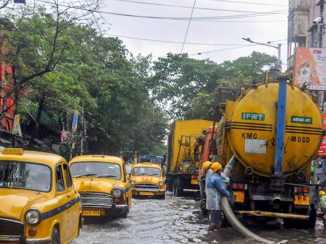 Kolkata Municipal Corporation (KMC) workers clear a water logged road after heavy rainfall. (File Photo: PTI)