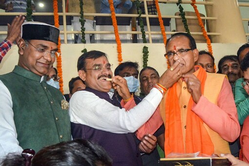 Madhya Pradesh Chief Minister Shivraj Singh Chouhan, BJP state president VD Sharma and others celebrate the party’s performance in bypolls, at the BJP headquarters in Bhopal, on November 2, 2021. (PTI Photo)