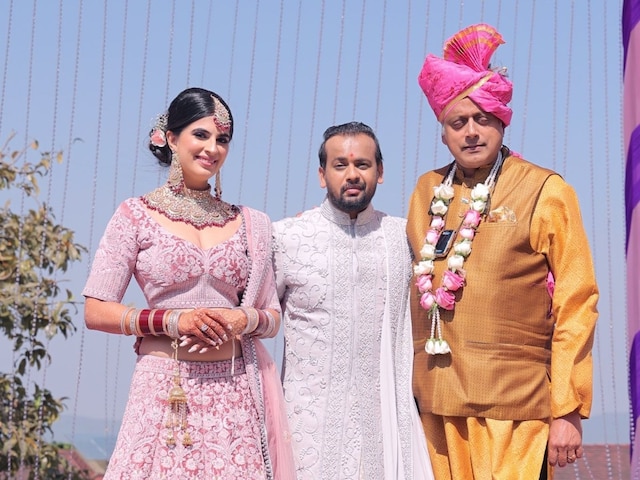 Photo shows Shashi Tharoor standing next to Abhishek Kulkarni and his wife, Chahat, at their wedding. Credits: Abhishek Kulkarni/Twitter.