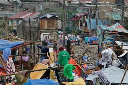 Residents salvage what's left of the their damaged homes caused by Typhoon Rai in Cebu city, central Philippines on Friday, Dec. 17, 2021. (Image: AP) Residents salvage what's left of the their damaged homes caused by Typhoon Rai in Cebu city, central Philippines on Friday, Dec. 17, 2021. (Image: AP)