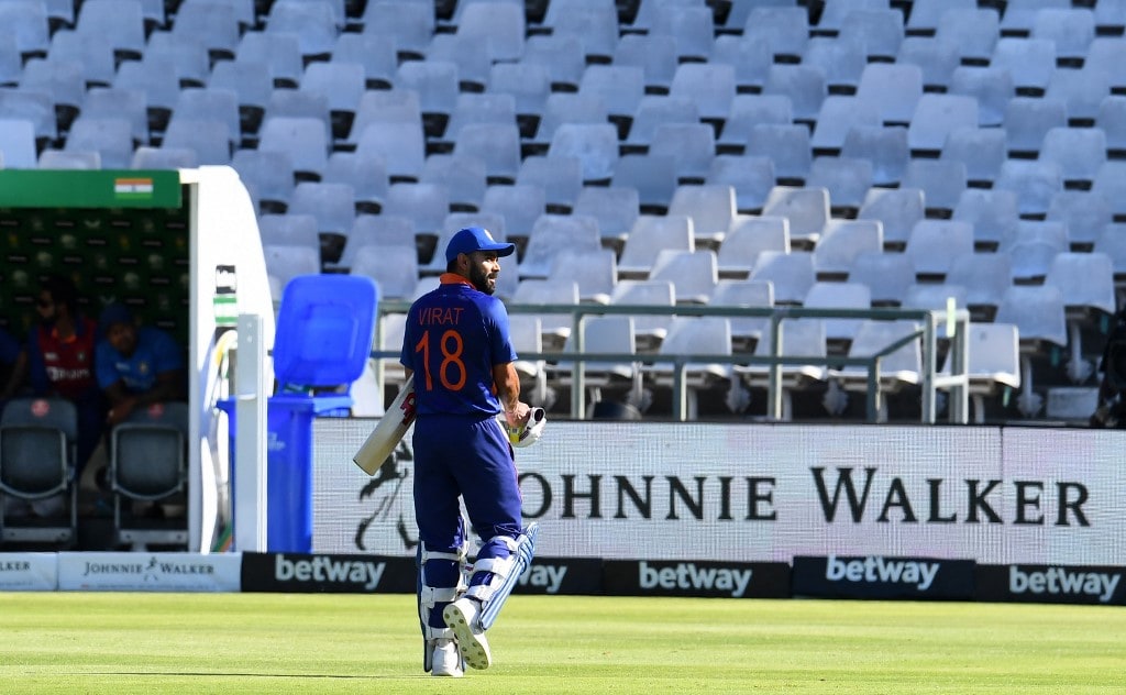 India's Virat Kohli walks back to the pavilion after his dismissal during the third one-day international (ODI) cricket match between South Africa and India at Newlands Stadium in Cape Town on January 23, 2022. (Photo by RODGER BOSCH / AFP)