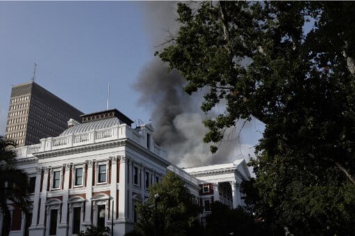 Smoke billows from the roof of a building at the South African Parliament precinct in Cape Town on January 2, 2022, during a fire incident.
Marco Longari / AFP Smoke billows from the roof of a building at the South African Parliament precinct in Cape Town on January 2, 2022, during a fire incident.
Marco Longari / AFP