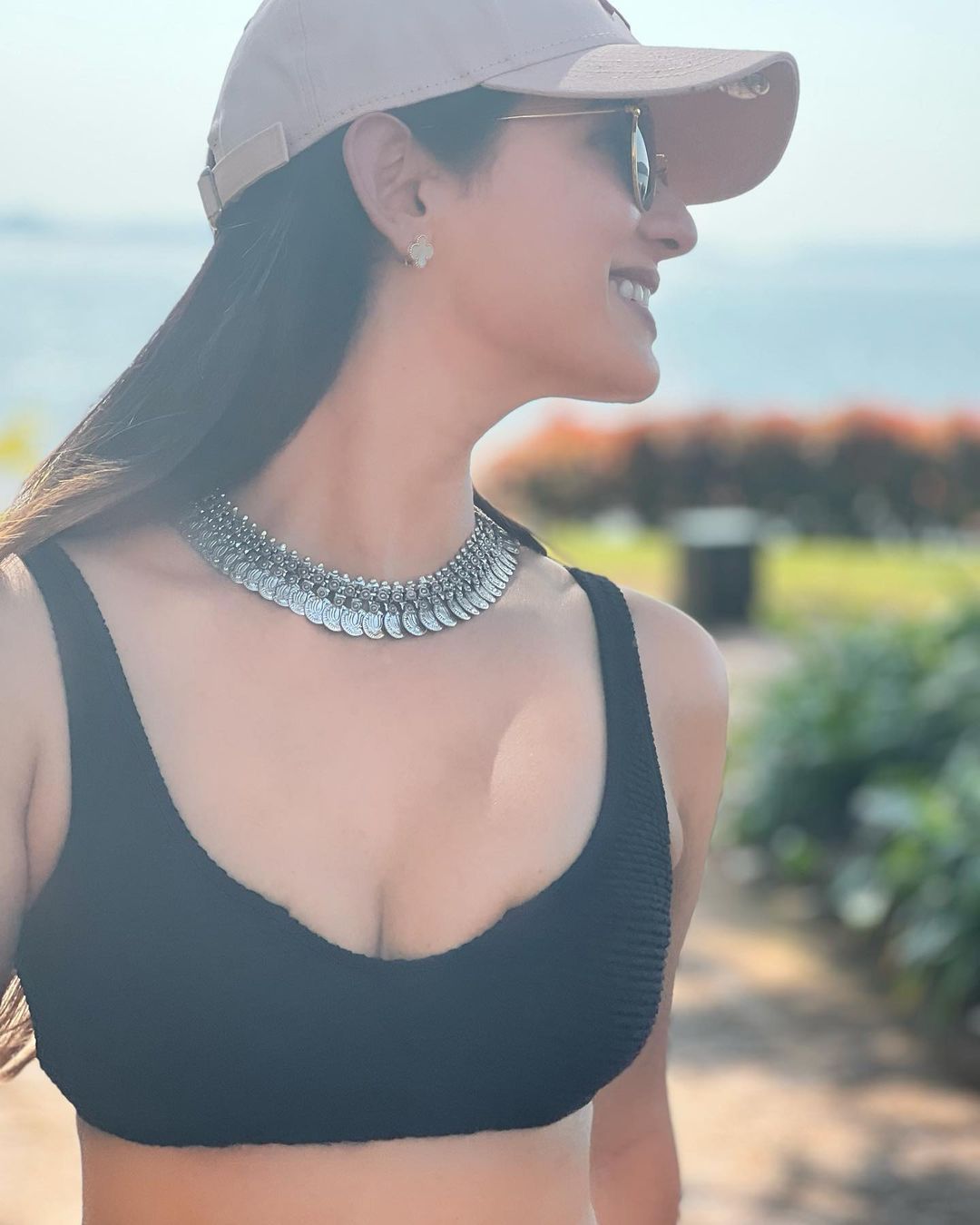  Sonal Chauhan pairs the black bralette with an embellished neckpiece and a cap. (Image: Instagram)