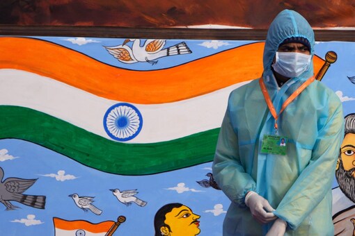 A civil defence health worker stands at the ceremonial Rajpath boulevard during India’s Republic Day celebrations, in New Delhi on January 26, 2022. (AP Photo/Manish Swarup)