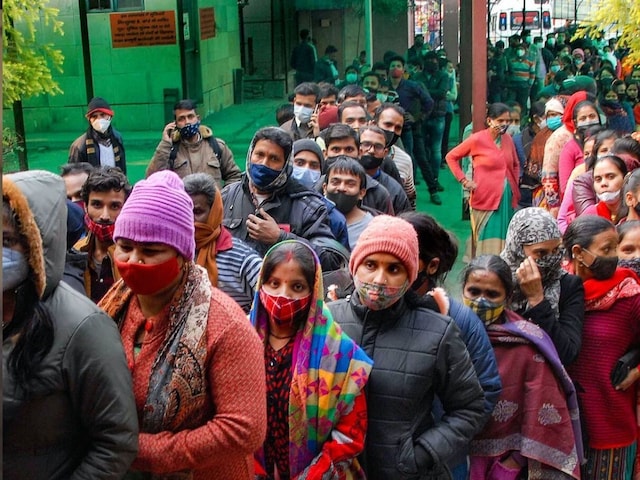 Beneficiaries stand in queues to receive Covid-19 vaccine dose, at district hospital in Noida on January 2, 2022. (PTI Photo)