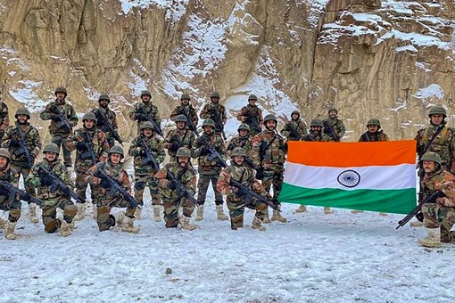 Indian Army soldiers pose with the Tricolour at the Galwan Valley in Ladakh on January 4, 2022. (PTI)