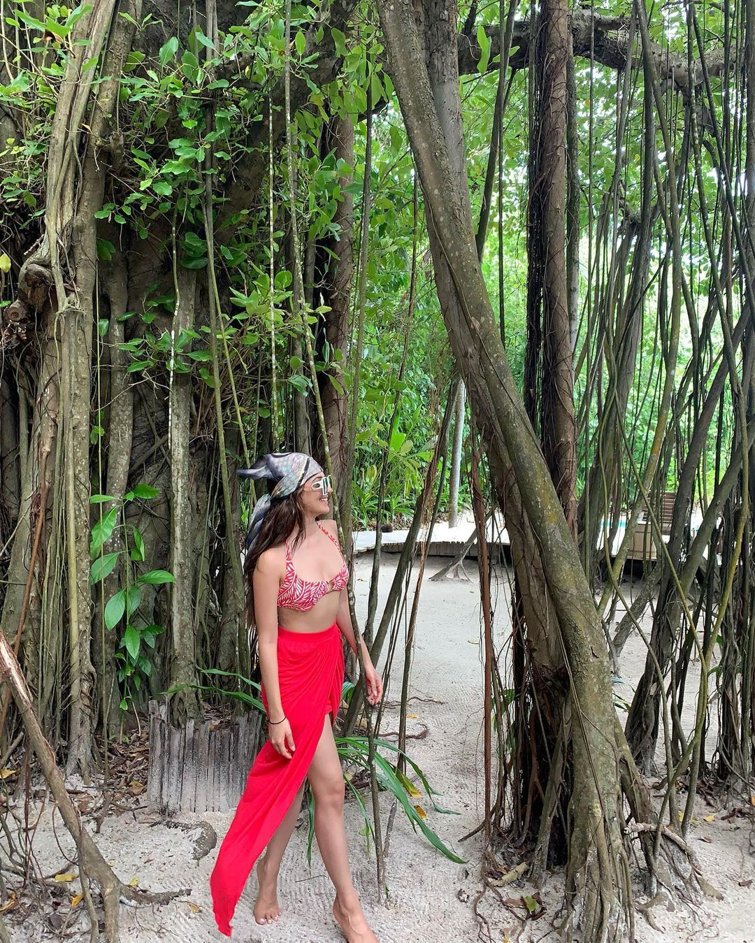Kiara Advani looks cool in the printed bikini top and red sarong.