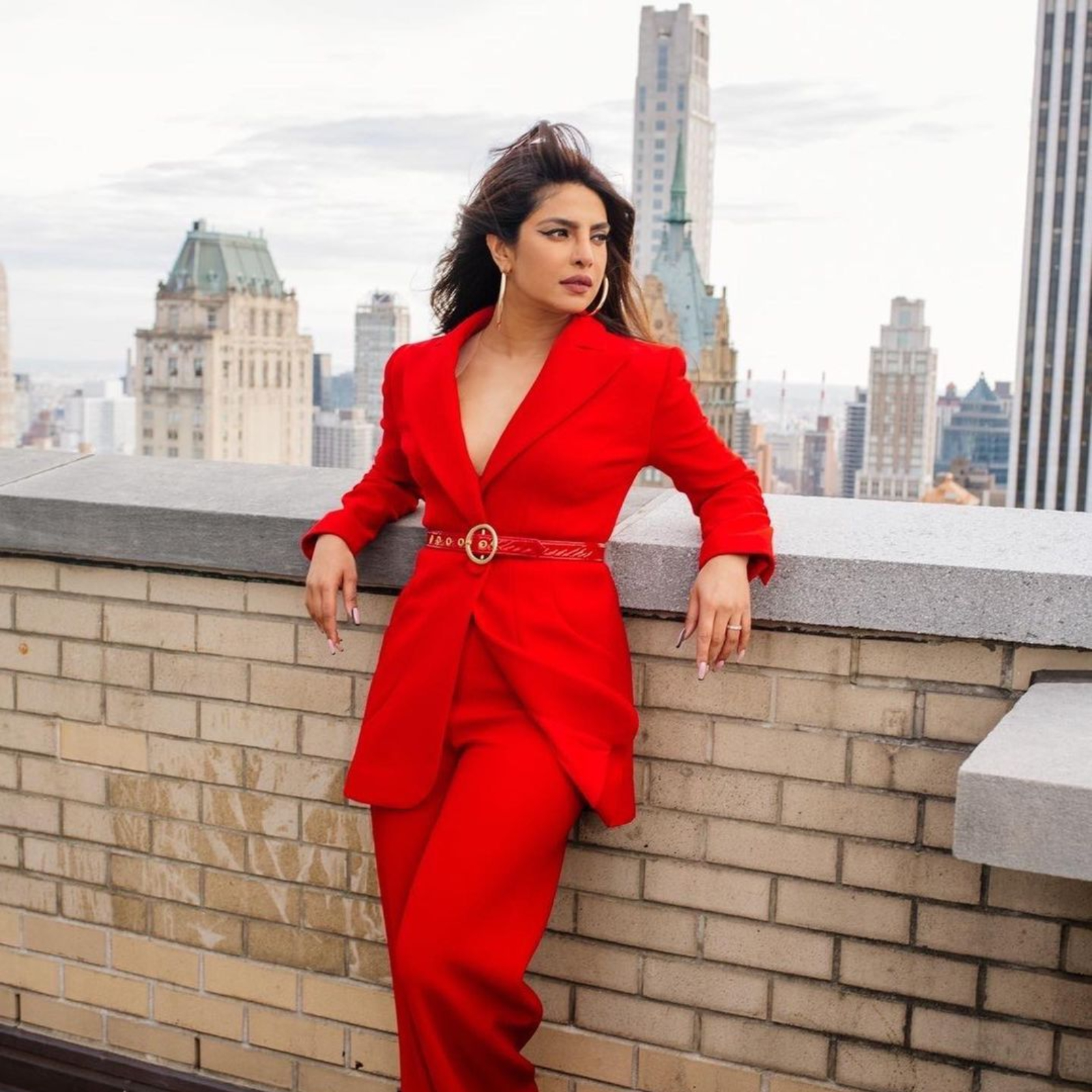 Priyanka Chopra looks uber chic in the smart red pantsuit.