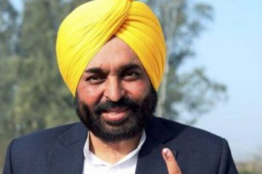 AAP chief ministerial candidate Bhagwant Mann shows his inked finger after casting his vote for Punjab Assembly polls, in Mohali, Sunday. (PTI Photo)