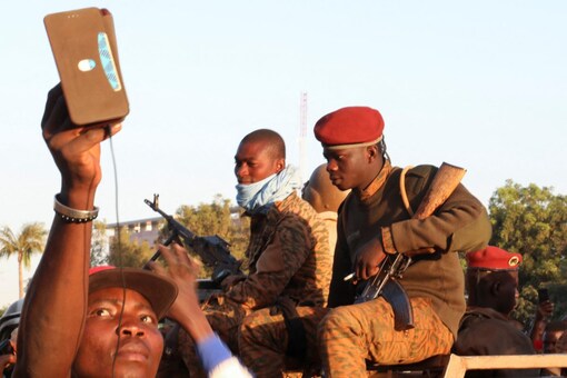 A man clicks a selfie with the Burkinabe soldiers as they depose president Kabore in Ouagadougou, Burkina Faso (Image: Reuters)