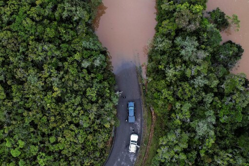 Cars stop before a flooded area, after Cyclone Batsirai made landfall, on a road in Vohiparara, Madagascar (Image: Reuters)