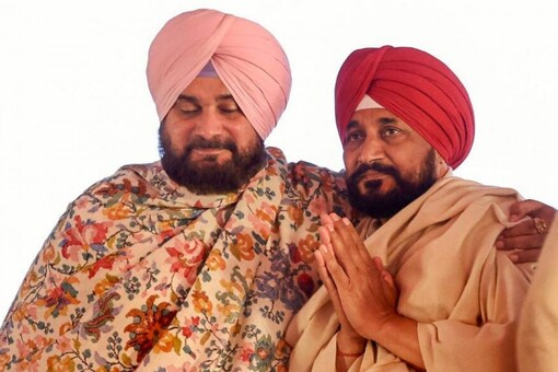 Punjab CM Charanjit Singh Channi (right) and state Congress chief Navjot Singh Sidhu have resolved to work together in a show of strength. (Image: PTI/File)