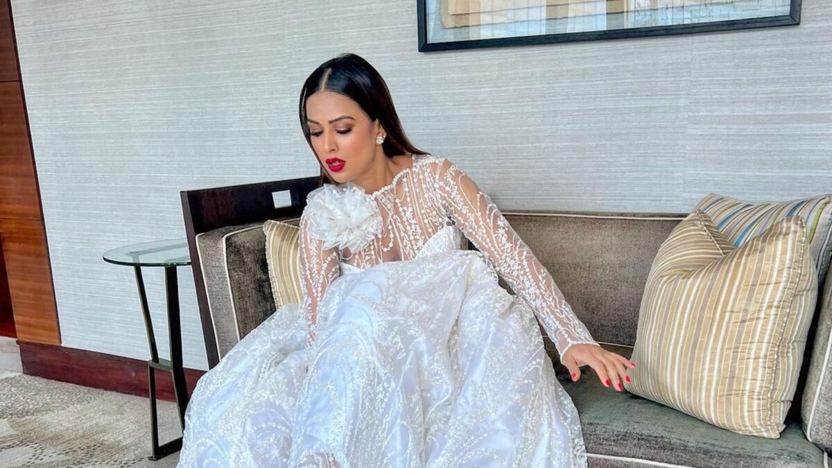 Nia Sharma Turns Heads With Her White Lehenga And Red Bold Heels At Her Brother's Wedding